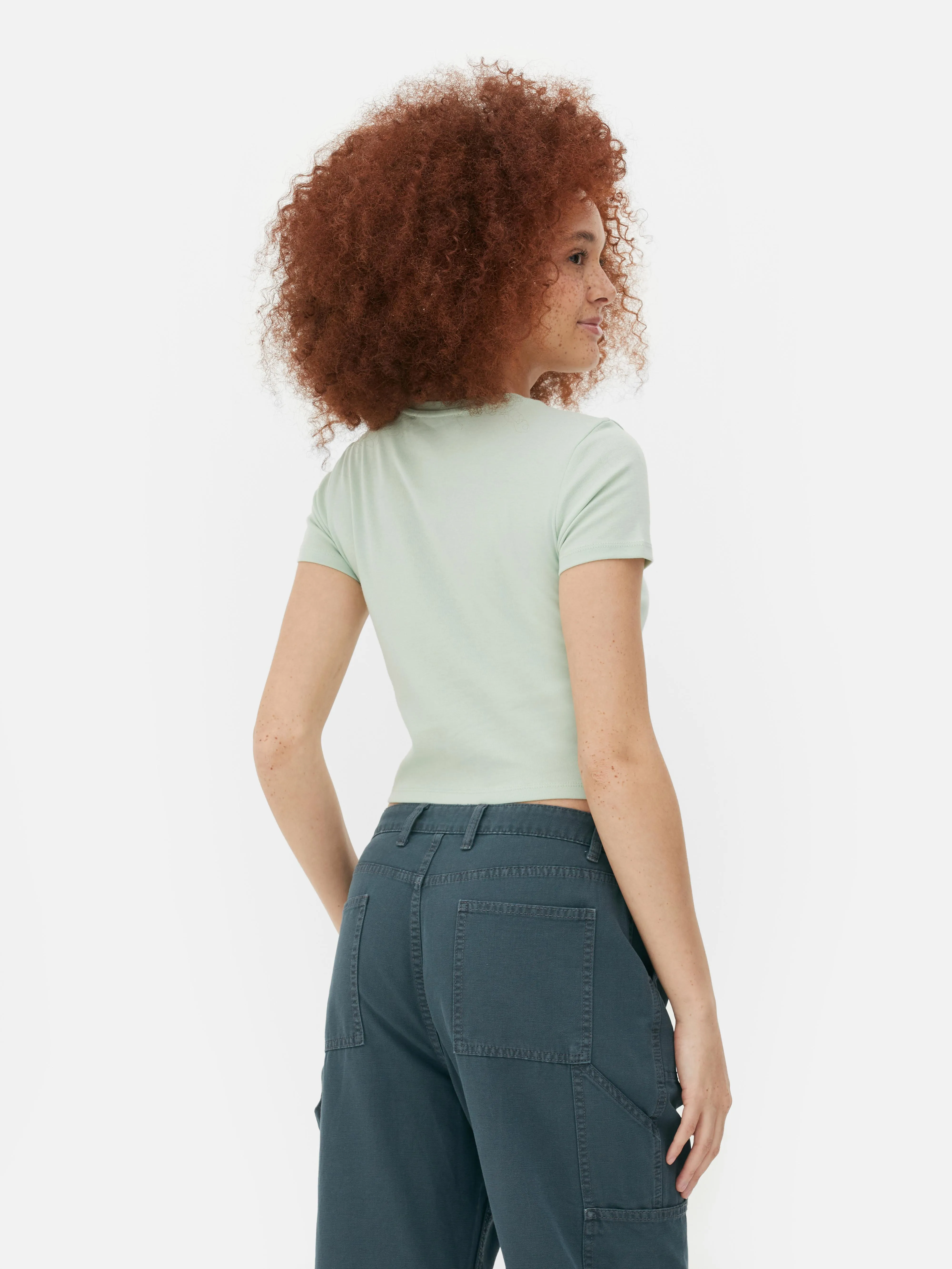 Camiseta corta tipo bebé con parche